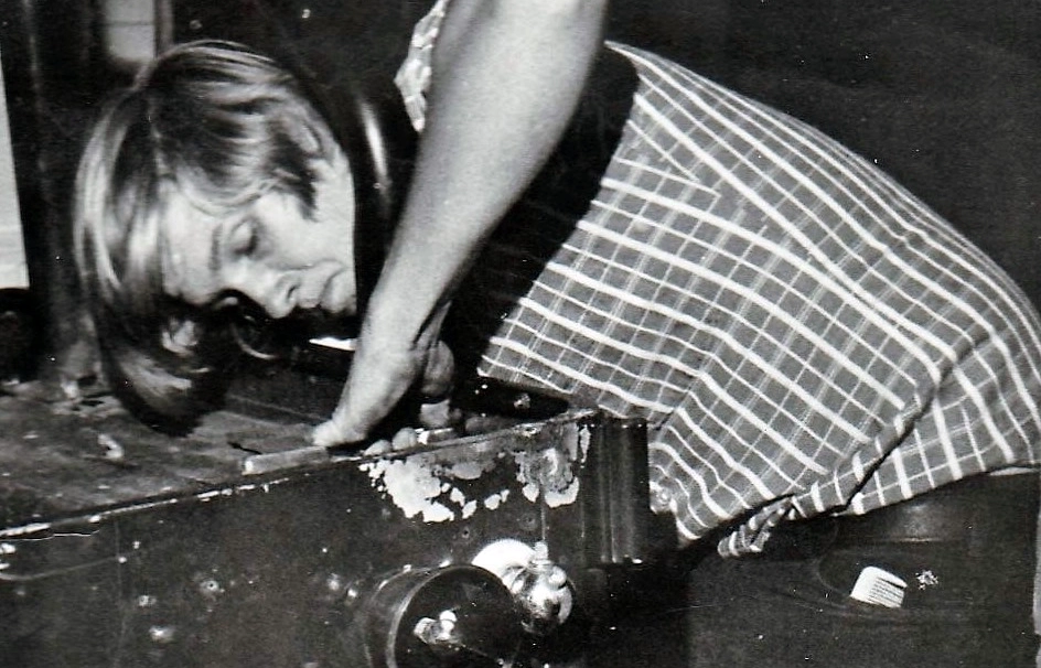 A black and white photo of Leif Hansen as a teenager working on a vehicle.